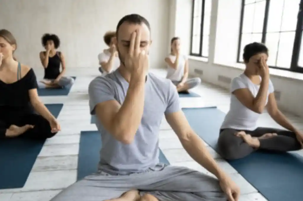 various people in a yoga class